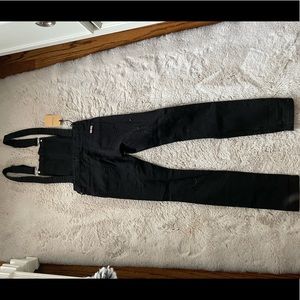 Black overalls with tags